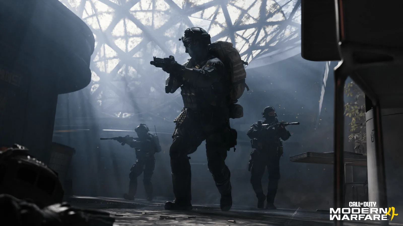 A DMZ squad advances through a dim industrial interior.